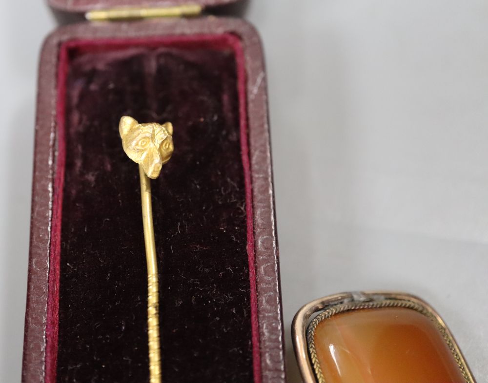 An early 20th century gold plate mounted propelling pencil, an agate set brooch, a 9ct gold and enamel medallion and a fox head pin.